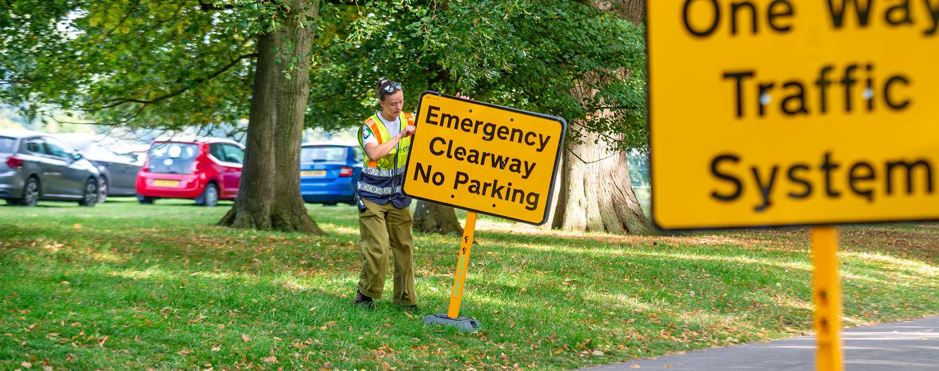 A yellow 'Get in lane' traffic sign.