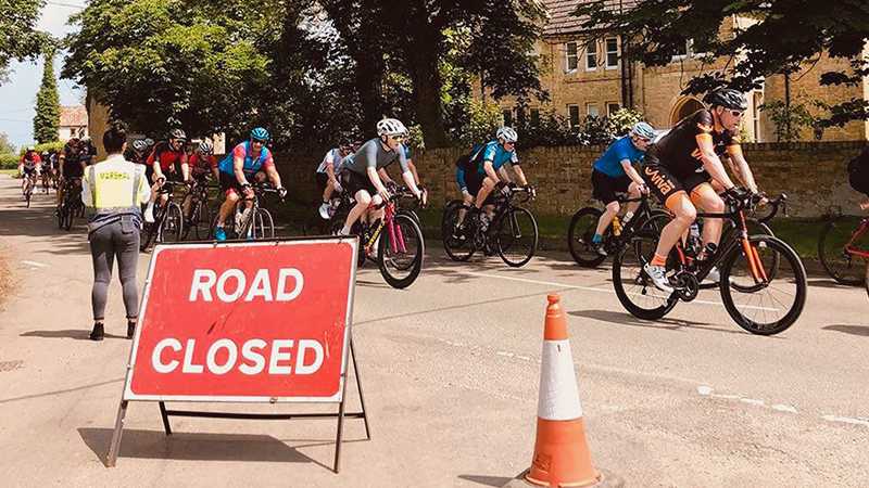 Professional cyclists riding through a picturesque village