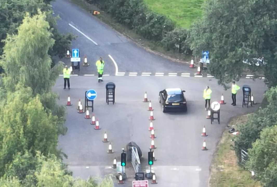 Crane shot of traffic being managed at a junction.