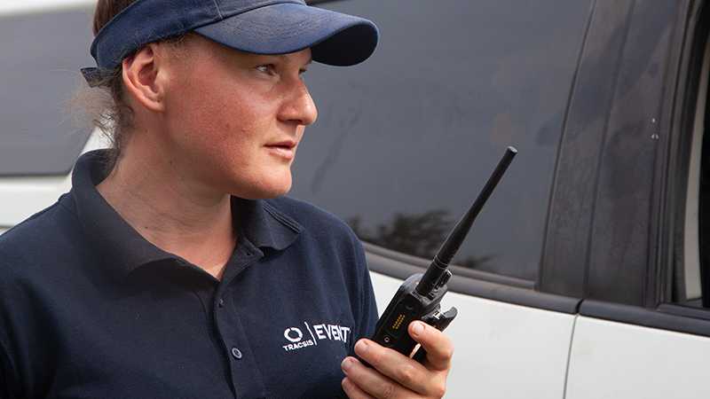 A Tracis Events Marshal using a walkie talkie