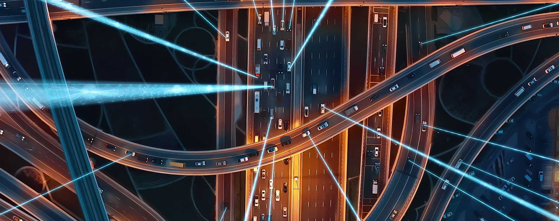 Traffic on a road at night time viewed from above.